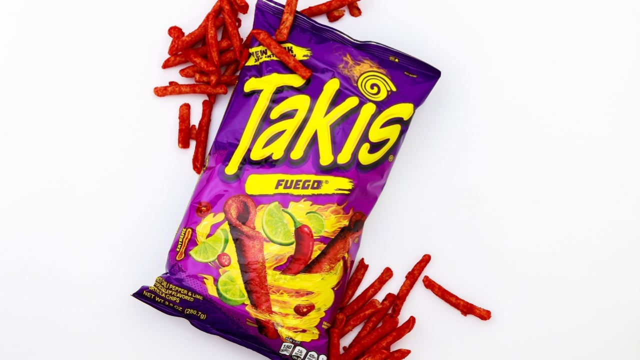 February 3, 2023. Spartanburg, SC USA. Rolling tortilla chips with chili peppers and lime by Takis Fuego