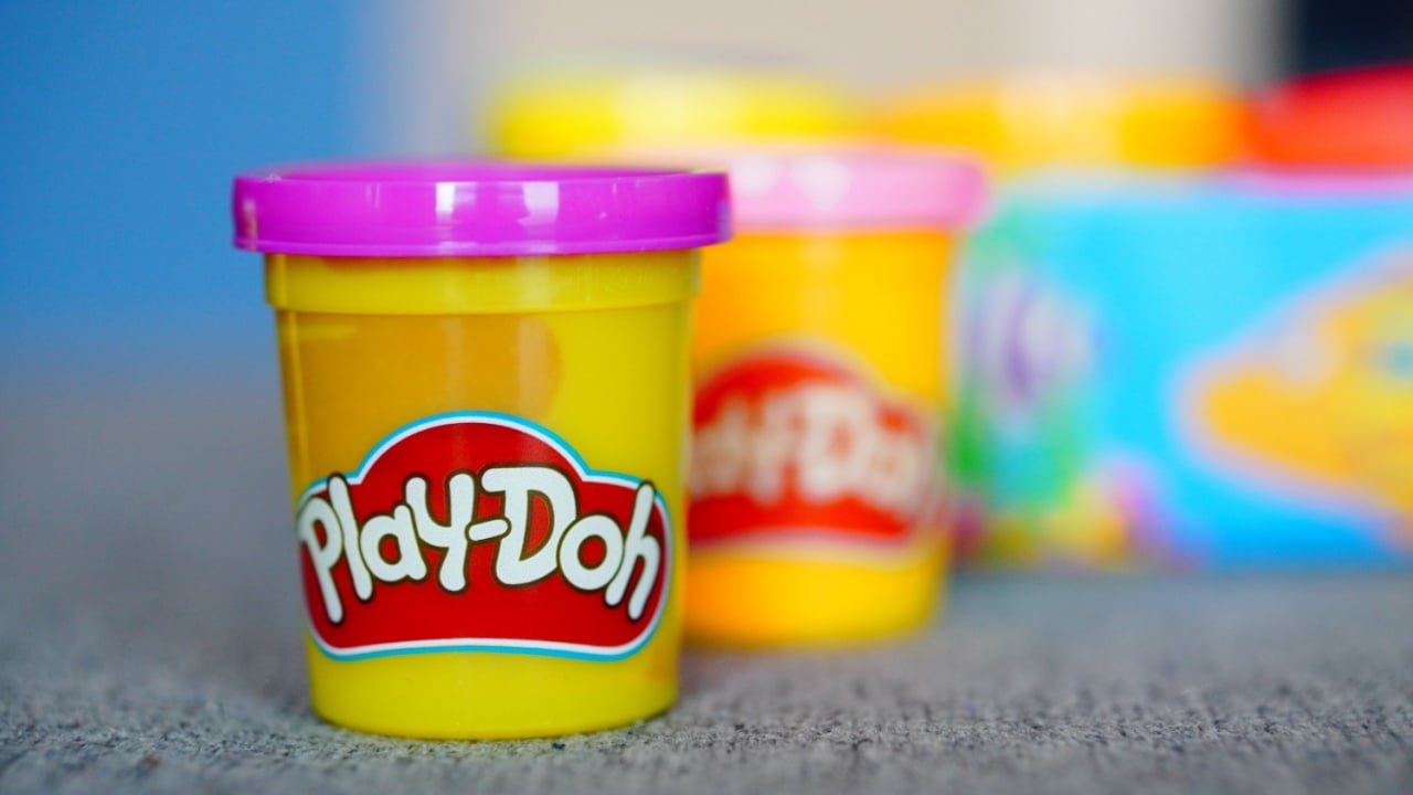 POZNAN, PL - Feb 13, 2023: A selective focus closeup of Violet Play-Doh clay and dough in a container