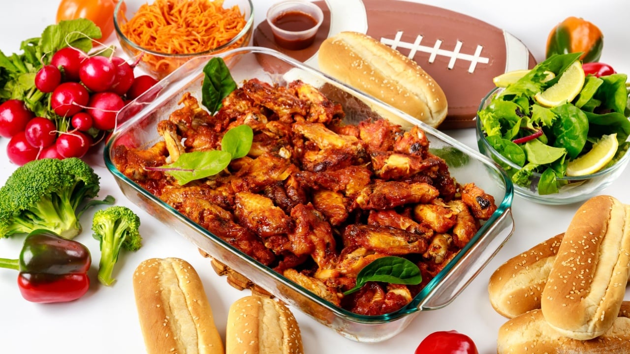 Wings come with a dip sauce and salad for football game party.