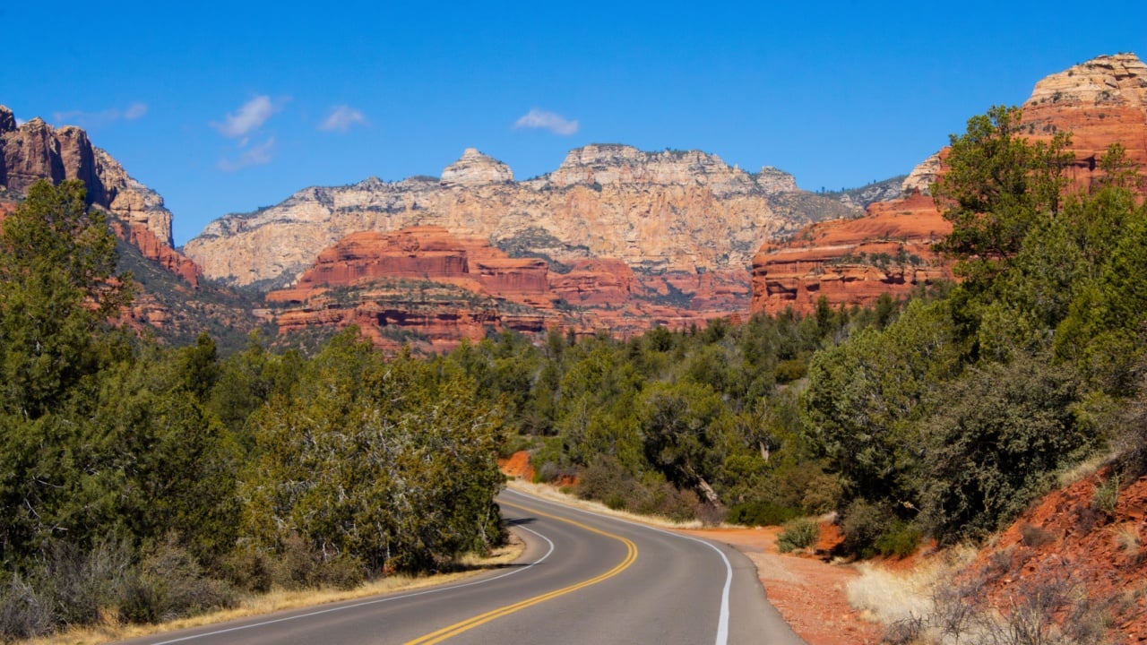 A road near Sedona, Arizona, with beautiful red rock mountains and desert trees in view, in Yavapai and Coconino Counties, near Clarkdale, Flagstaff, Cottonwood, and Village of Oak Creek, February '24