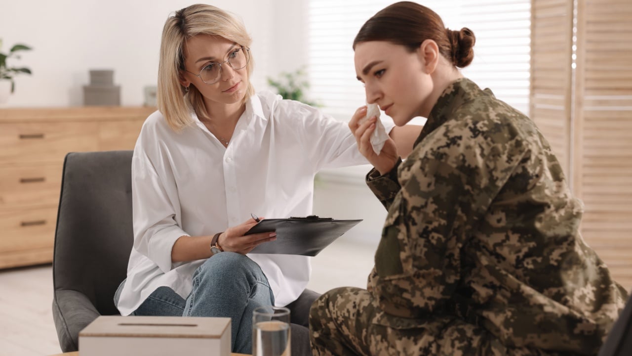 Psychotherapist working with military woman in office