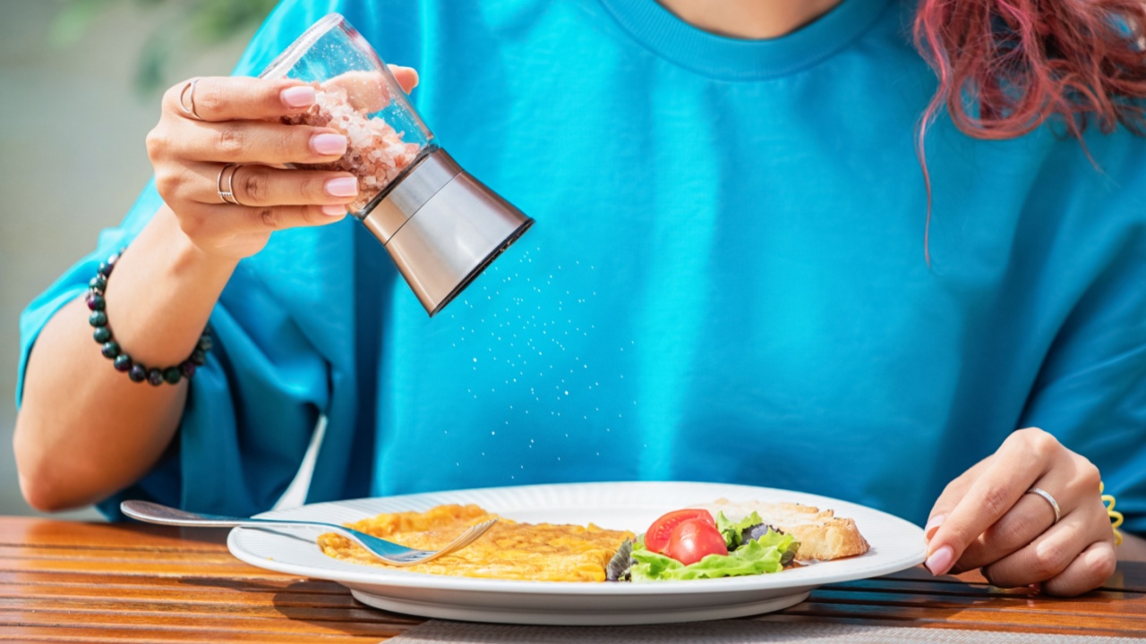 Tasty dishes in a cafe with added salt, highlighting culinary flavor but also concerns about excess sodium and health risks.