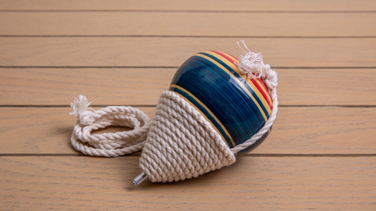 Handmade Mexican wooden toy.spinning top made of colored wood on a wooden table