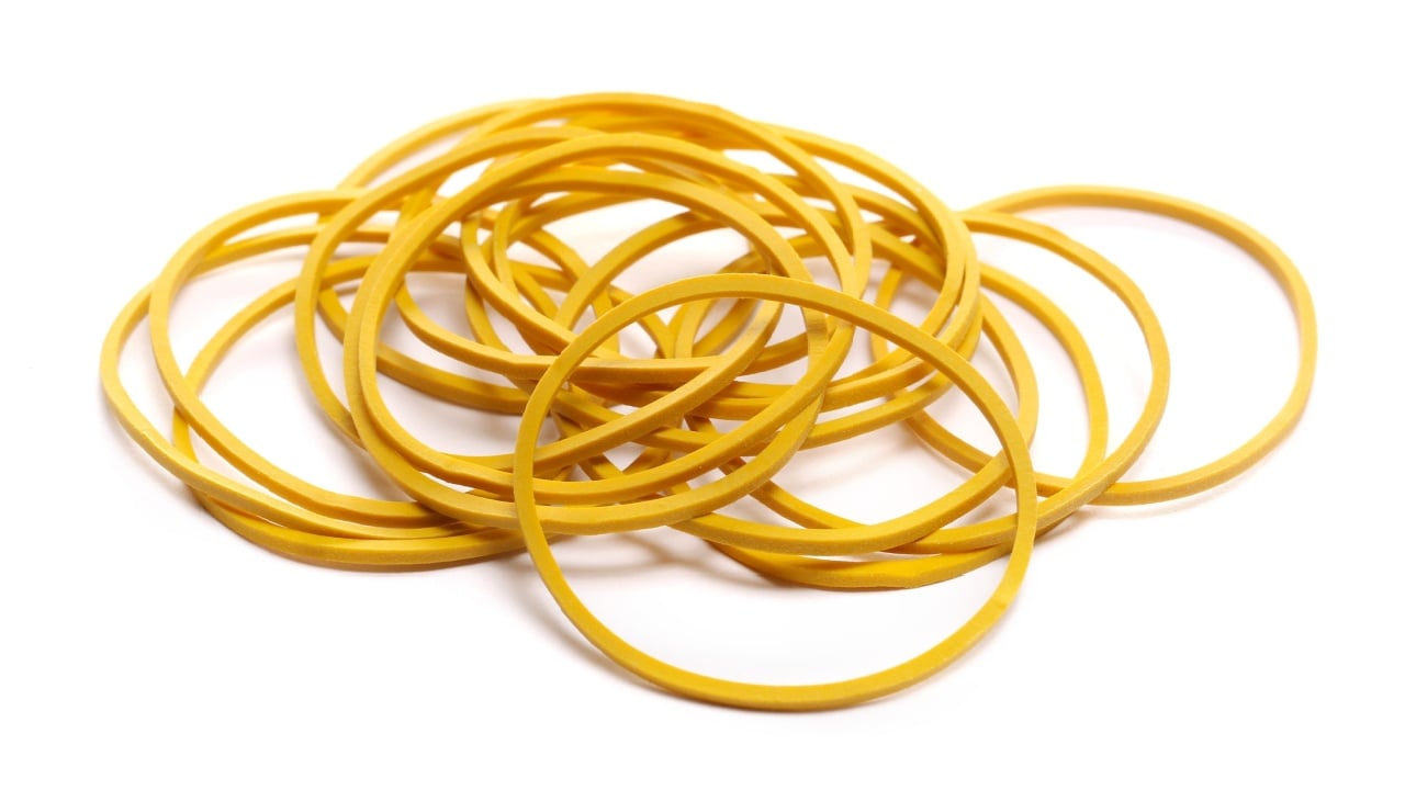 Yellow rubber bands isolated on white, side view