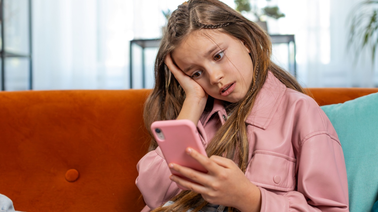 Upset girl using smartphone playing game loses becoming surprised sudden lottery results, bad news, fortune loss, fail education study test. Female teen child kid at home in living room sits on sofa.