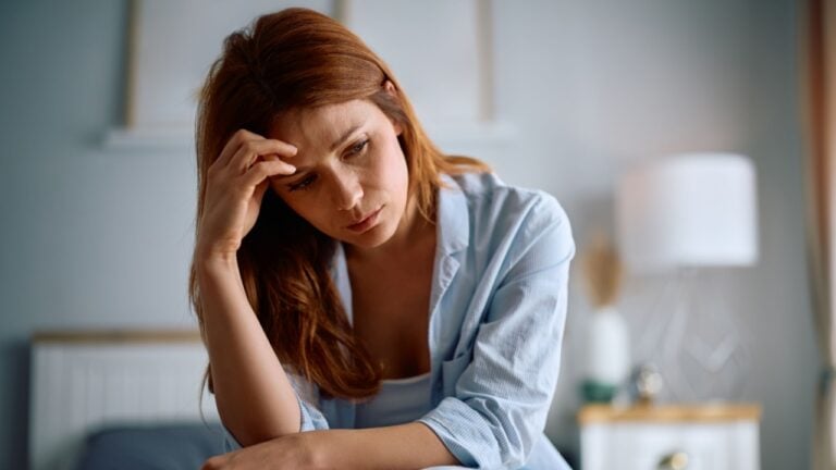 Mid adult woman feeling depressed after waking up in the morning.