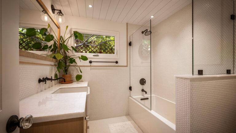 Cozy yet refined home with natural light, modern kitchen, designer dining, spa-like bathrooms, and private pool with greenery