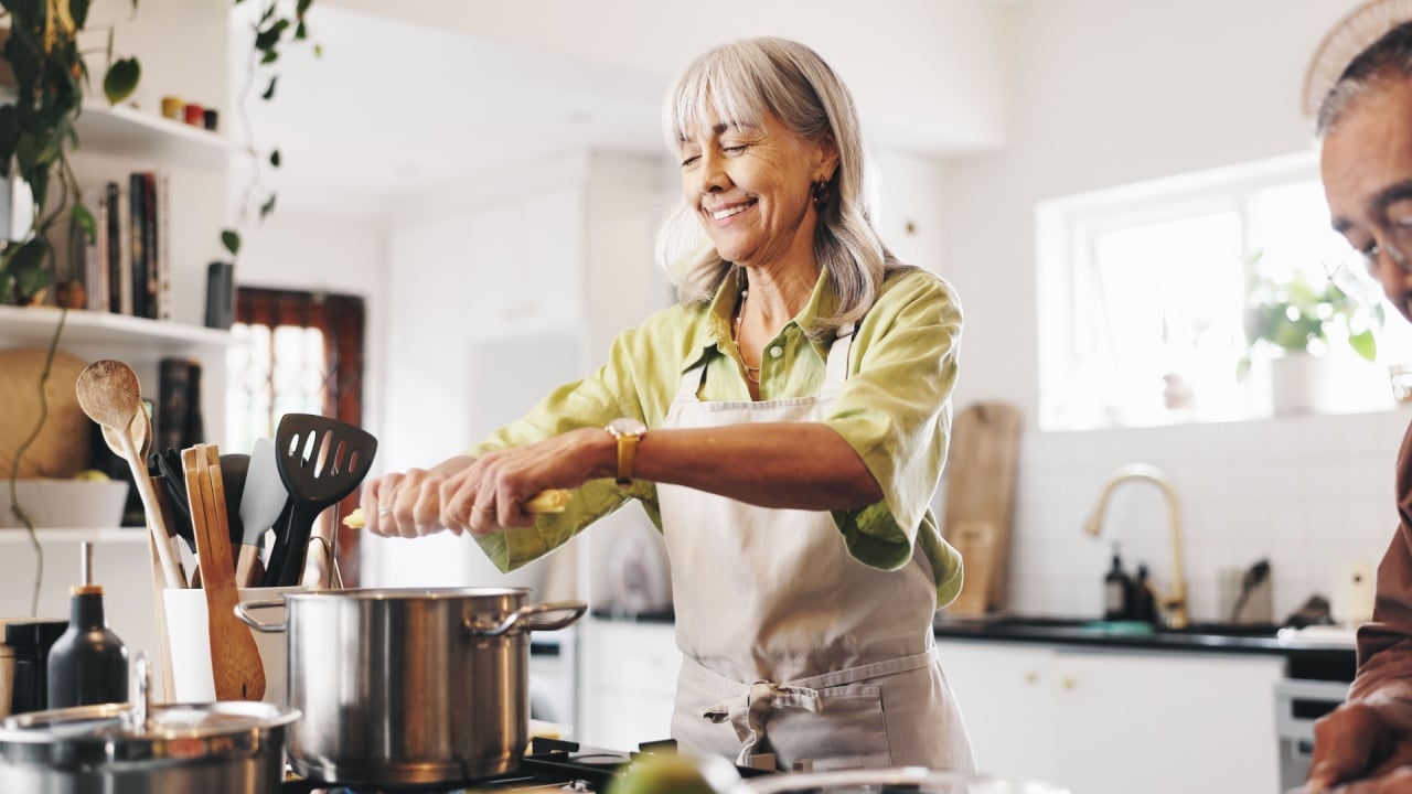 Pasta, cooking and mature couple in kitchen in home with Italian dinner, meal or dish. Happy, pot and man with woman for preparing supper with health, wellness and nutrition in house together.