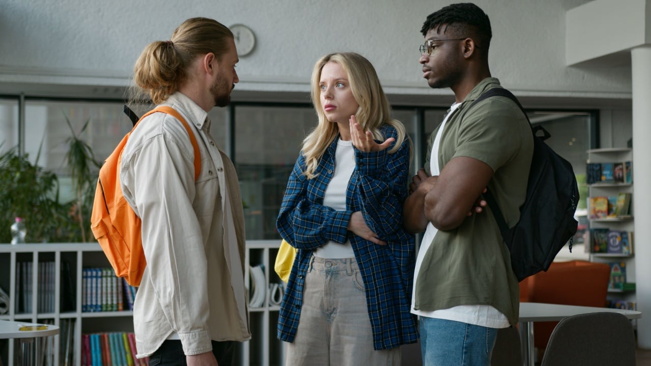 Group of diverse college friends three multiracial students meeting in university hall upset Caucasian woman girl frustrated African American men guys support calming talking multicultural friendship