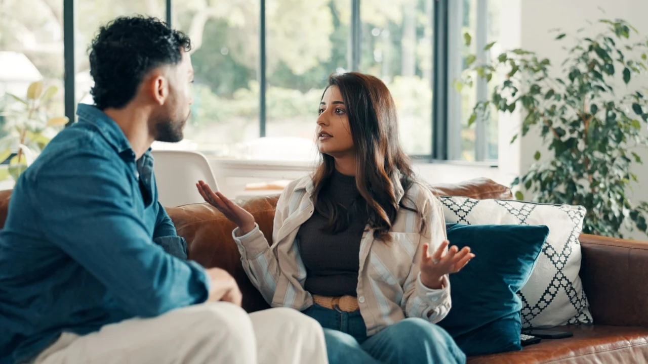 Couple, living room and argument with mistake, stress and drama in home or apartment. Frustrated, woman and man with dispute, angry and fight with toxic marriage and anxiety or crisis with partner