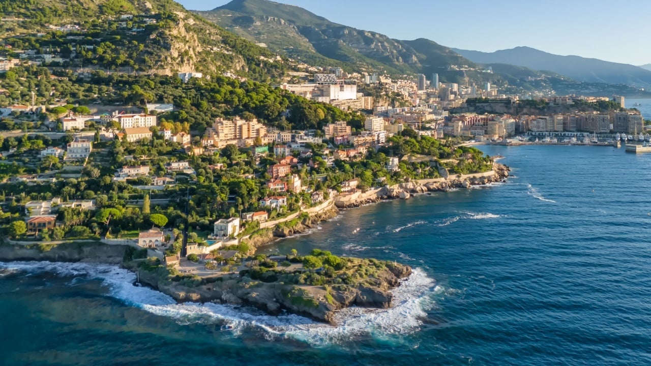Aerial view of the French Riviera coastline between Nice and Monaco. Luxury villas line the Mediterranean Sea along the magnificent Cote d'Azur in summer