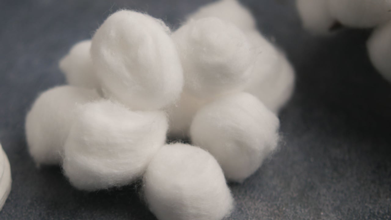 Cotton balls and pads on a table for cleaning tasks
