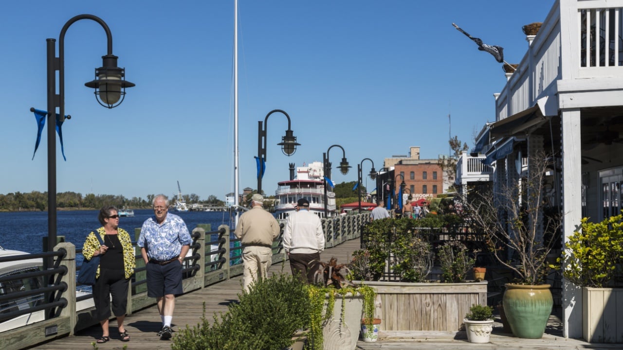 WILMINGTON, NORTH CAROLINA/USA - OCTOBER 19, 2014: Unidentified tourists walk along the River Walk. The River Walk is a tourist attraction boardwalk along the historic town.