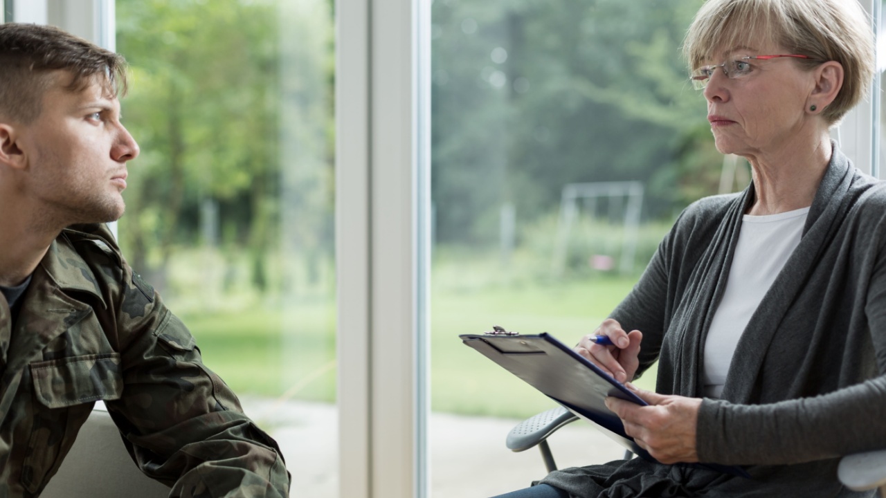 Image of psychologist helping soldier to overcome depression