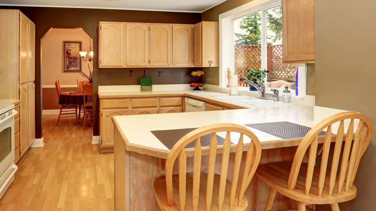 Kitchen room interior with light brown cabinets and tile counter top. Northwest, USA