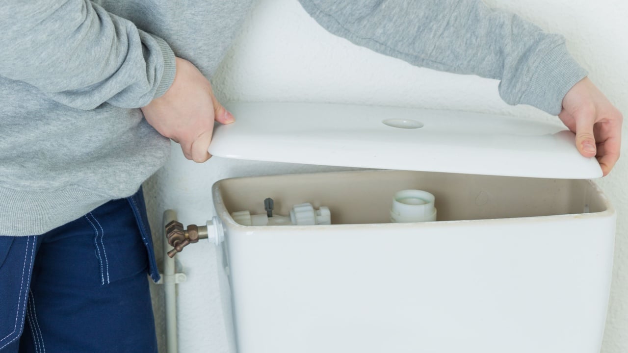 confident woman repairing toilet flush
