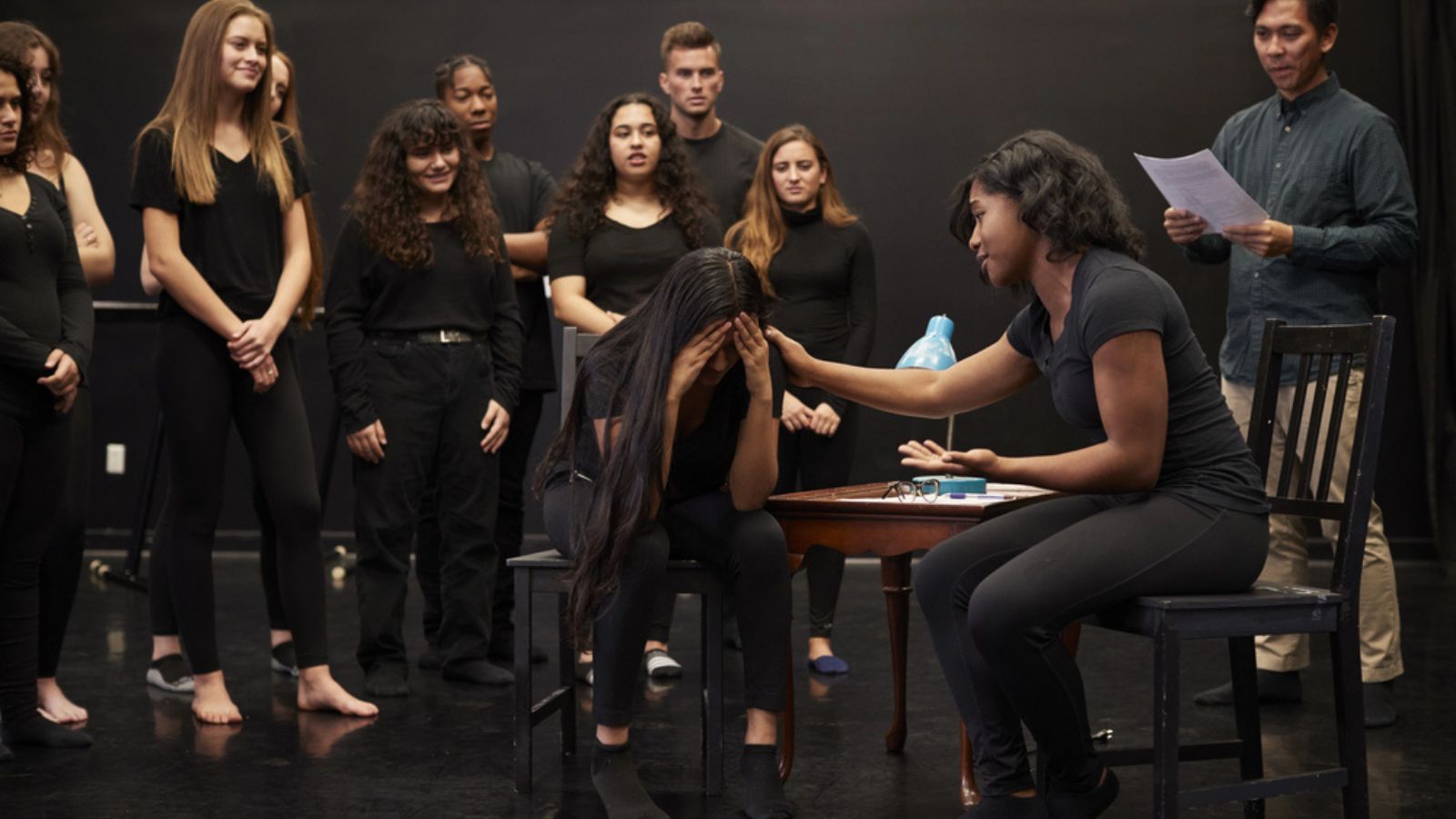 Teacher With Male And Female Drama Students Performing Arts School In Studio Improvisation Class