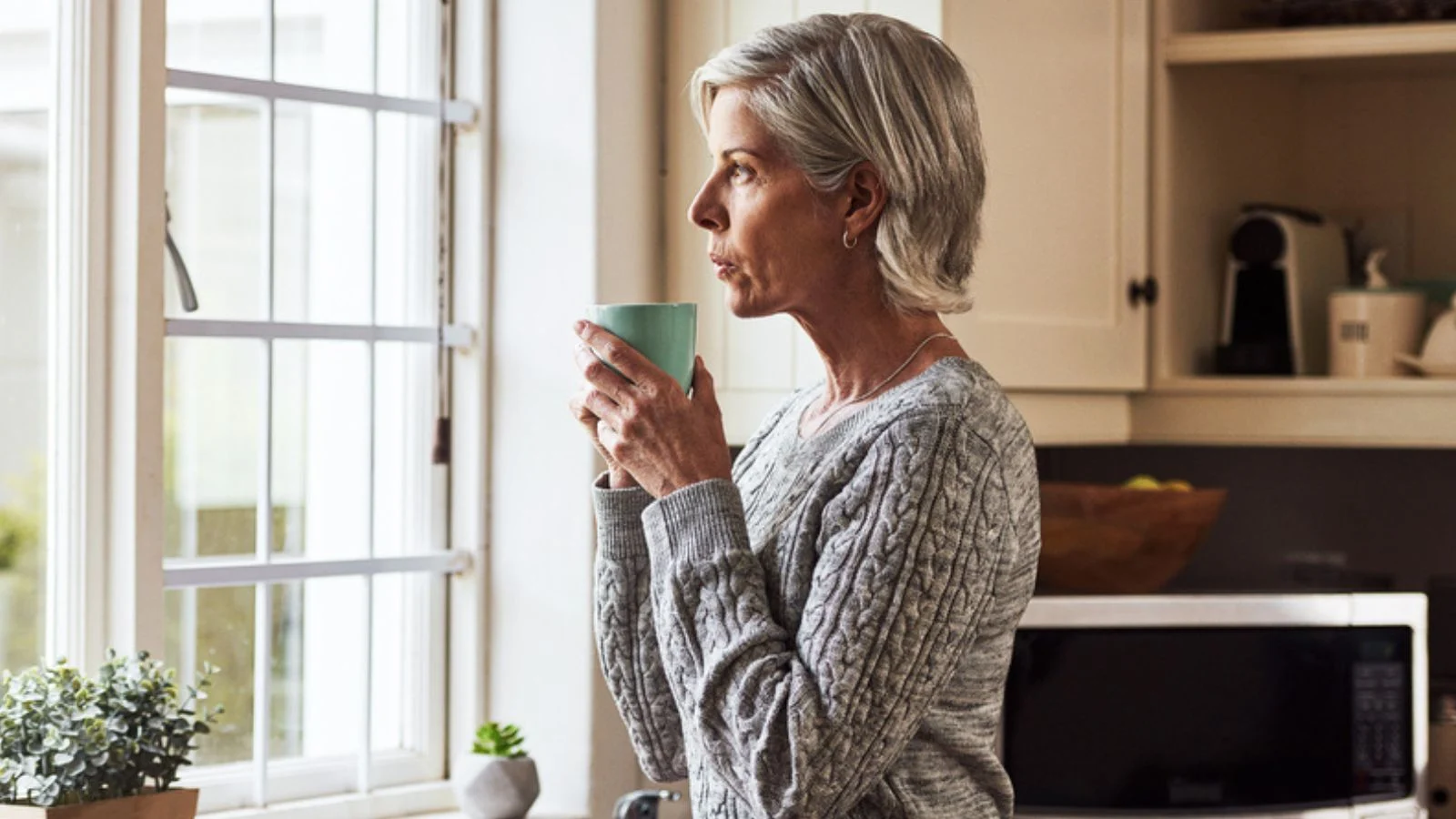 Thinking, home retired old senior woman with coffee morning kitchen