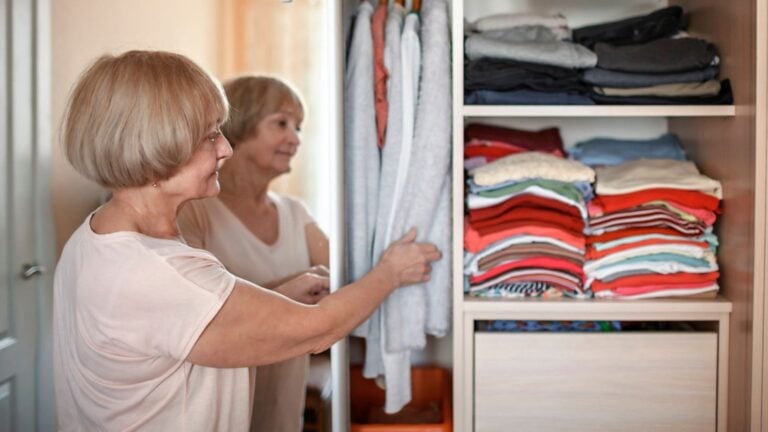 senior woman retired choose outfit closet organize donate