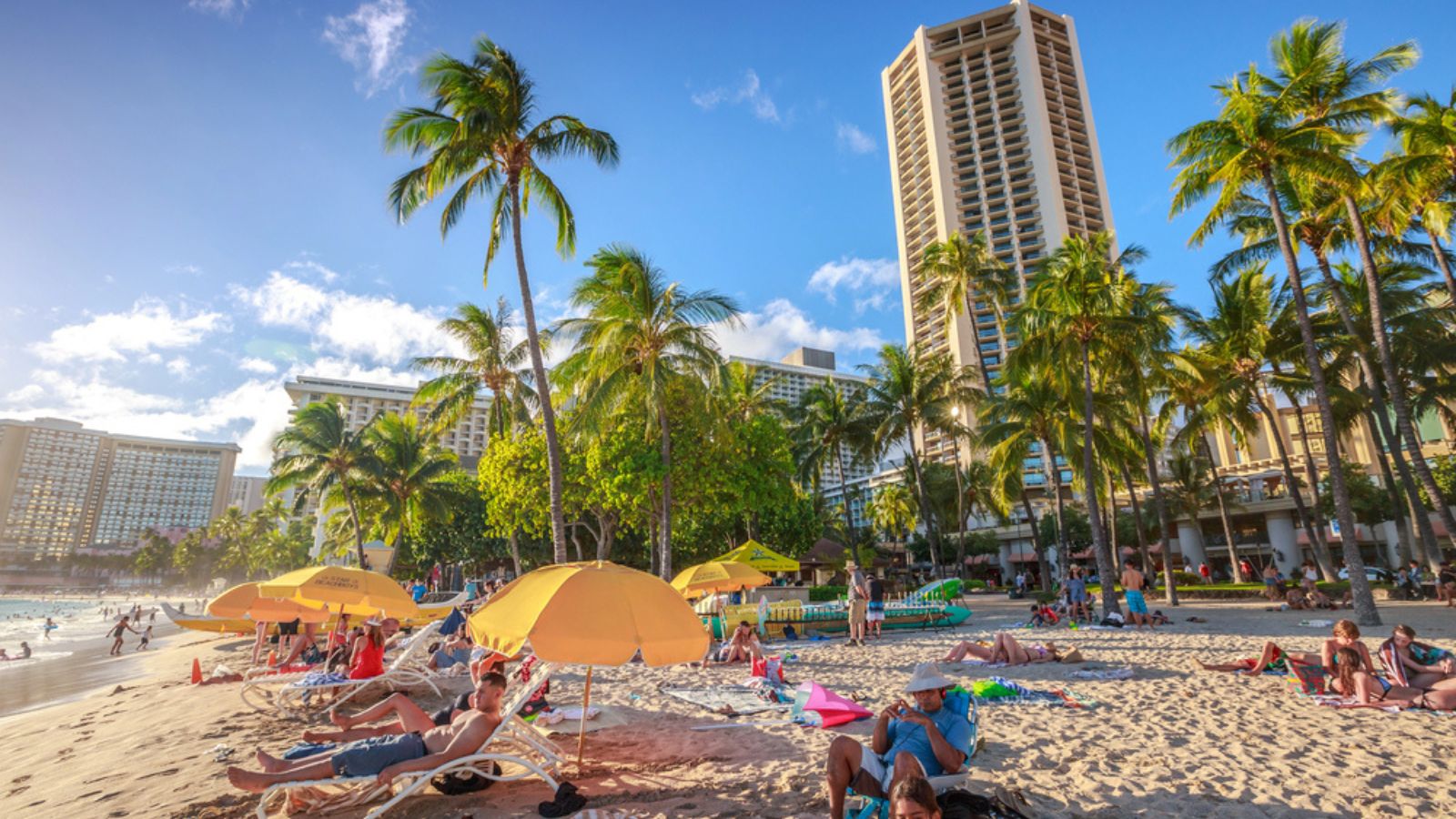 tourist sunbathing on Waikiki beach at sunset. Waikiki beach, South Shore, is neighborhood of Honolulu and the most popular of Hawaii