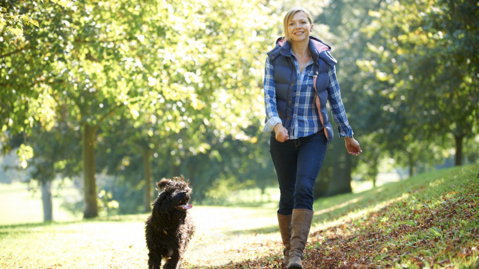 Girl is on the walk with dog