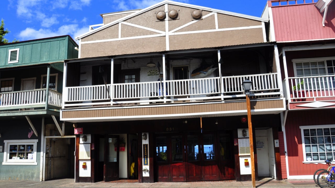 LAHAINA, HI - JULY 16: Old Lahaina storefronts on the Lahaina, Maui waterfront on July 16, 2012. Lahaina was once capital of Hawaii and home to the whaling industry. Now it is a pretty tourist town.