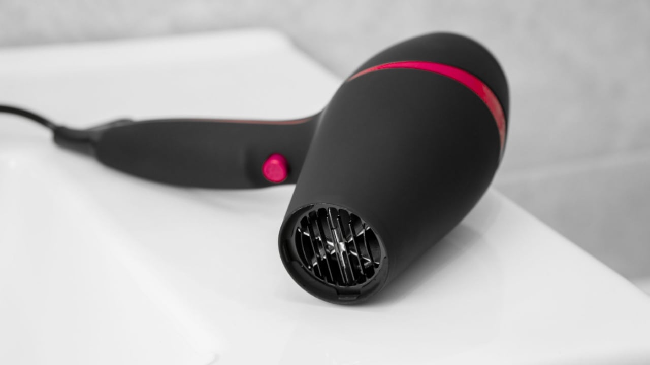 Hair dryer in a bathroom. Hair care