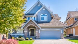 Beautiful exterior of newly built luxury home. Yard with green grass and walkway lead to front entrance.