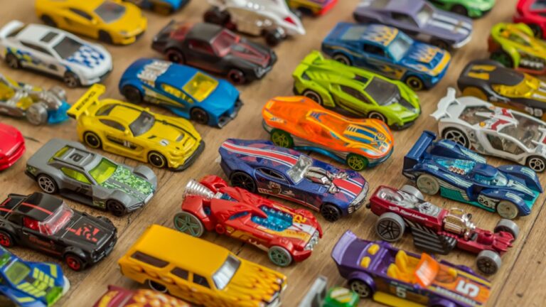 Ivanovo, Russia - June, 2019 : The group of colorful toy car collection on wooden background. Hot Wheels. Top view