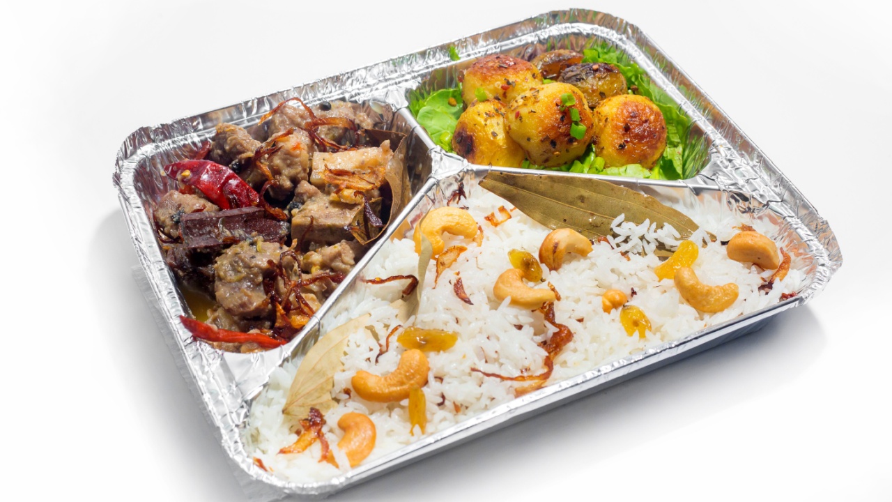 The Food Warmer Aluminum Foil Rectangular Disposable Parcel lunch box. Thai and Chinese style meal. 450ML 3 parts Foil Container lunch food box. Top view, flat lay at white background.