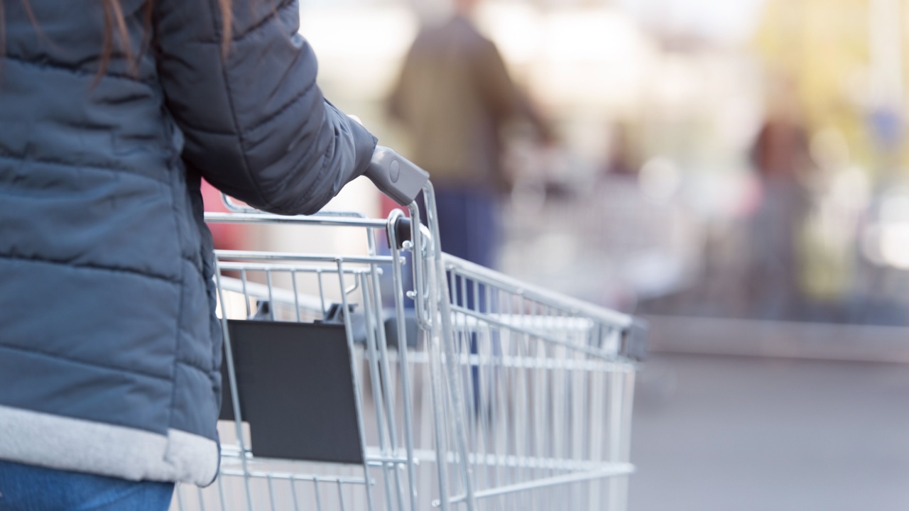 Woman pushing an empty shopping cart