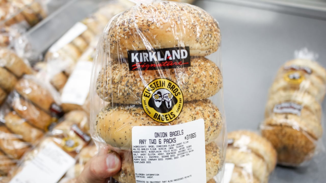Los Angeles, California, United States - 02-19-2020: A hand holds a package of Kirkland Signature Einstein Bros. Bagels, on display at a local Costco.