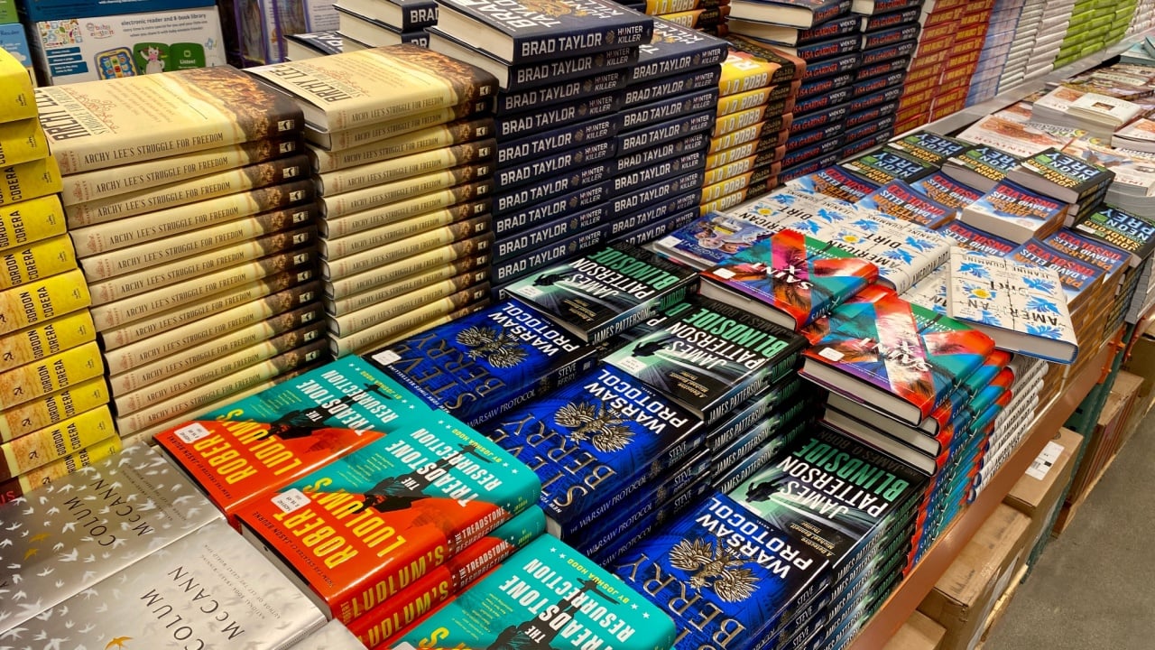 San Jose, CA - February 28, 2020: Piles of hard bound fiction books on a table for sale inside a Costco warehouse.