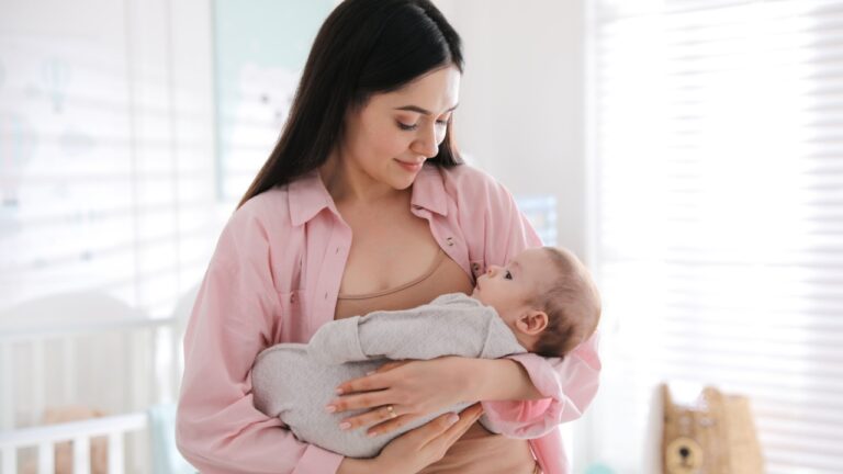 Young woman with her cute baby at home