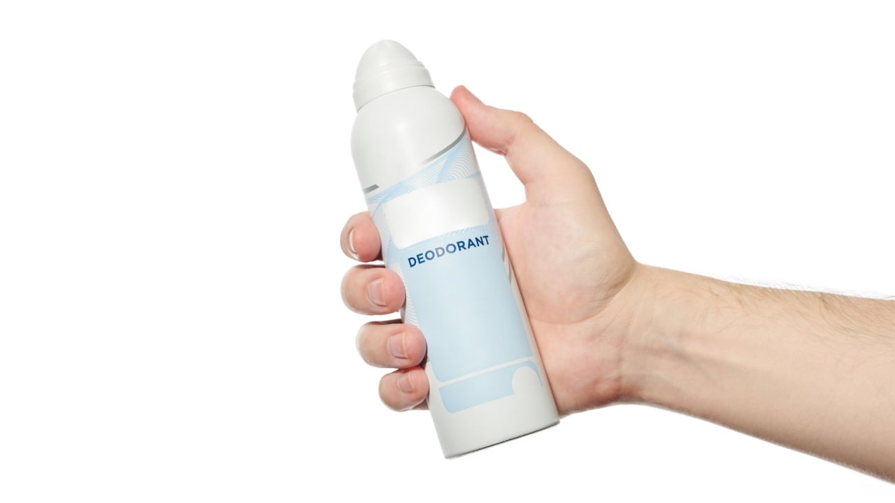 Deodorant in hand pattern. Antiperspirant spray bottle on white isolated background.