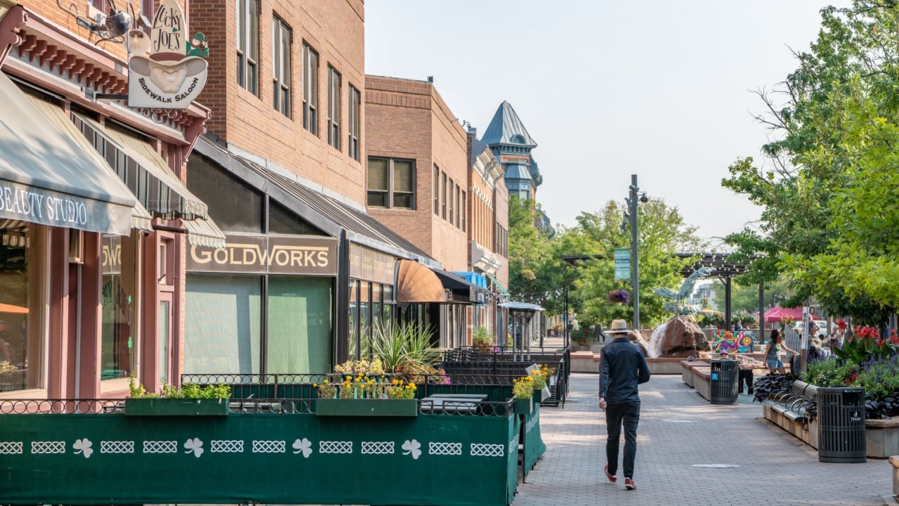 Fort Collins, CO - August 30,2021: A man sightsees in the famous Old Town Square, in the center of town.