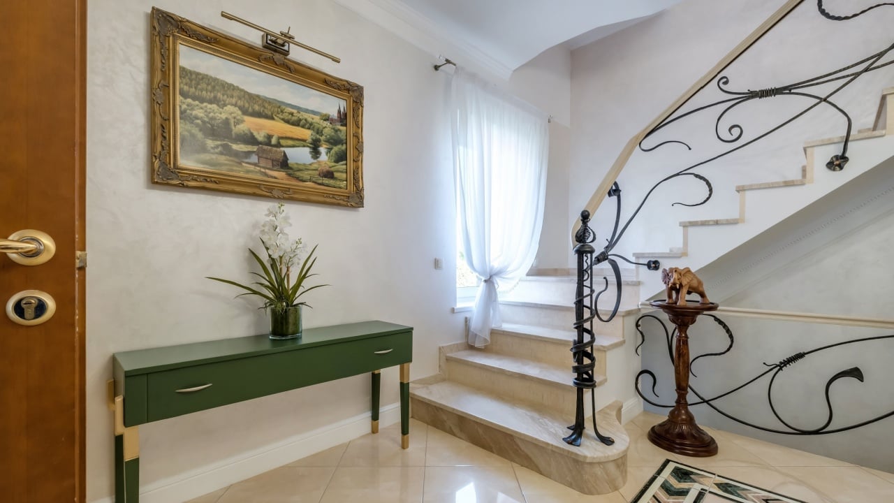 MINSK, BELARUS - AUGUST, 2021: hall interior flat in light style design with wrought iron stairs
