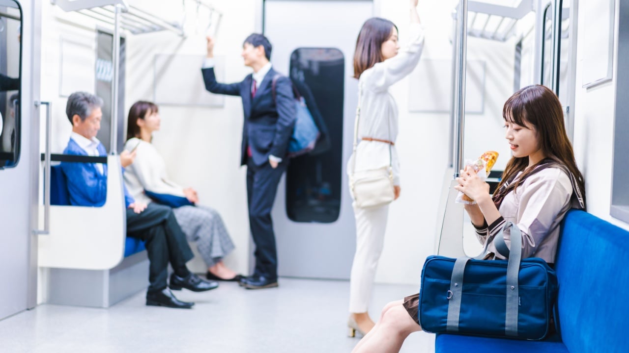 Students eating bread on the train