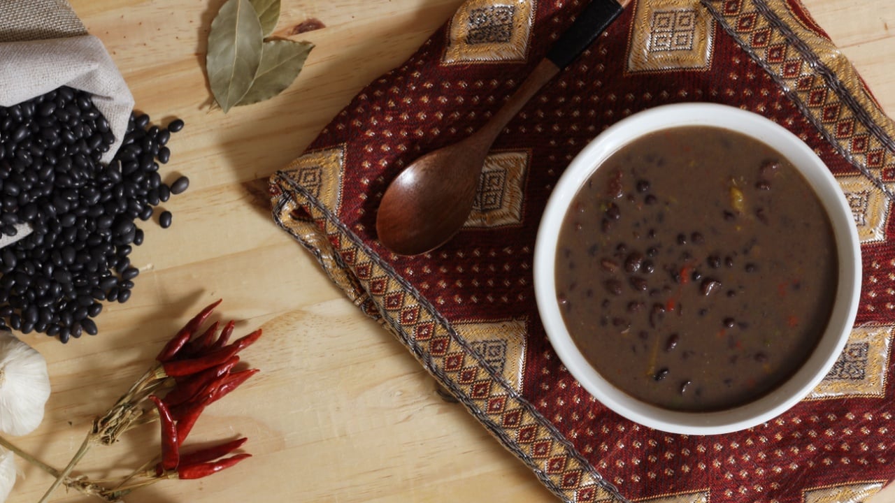 Black Bean Chili on Wooden Table With Spices and Dried Black Beans