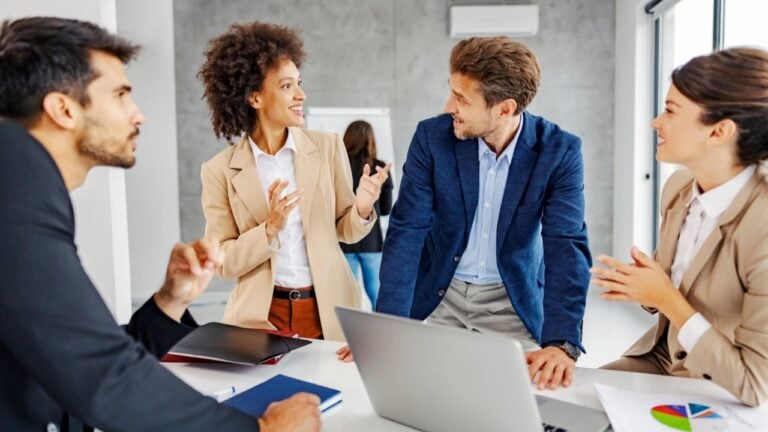 A multiracial group of economist brainstorming about finances and stock market.