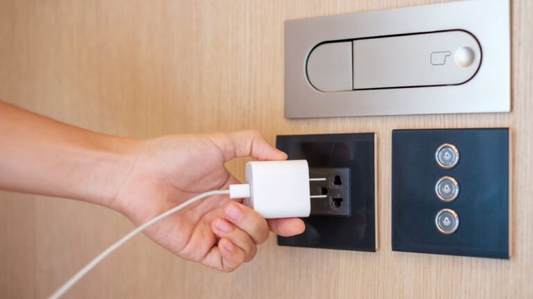 Closeup finger unplugging or plugging of electricity device at home. Energy Saving, power, electrical