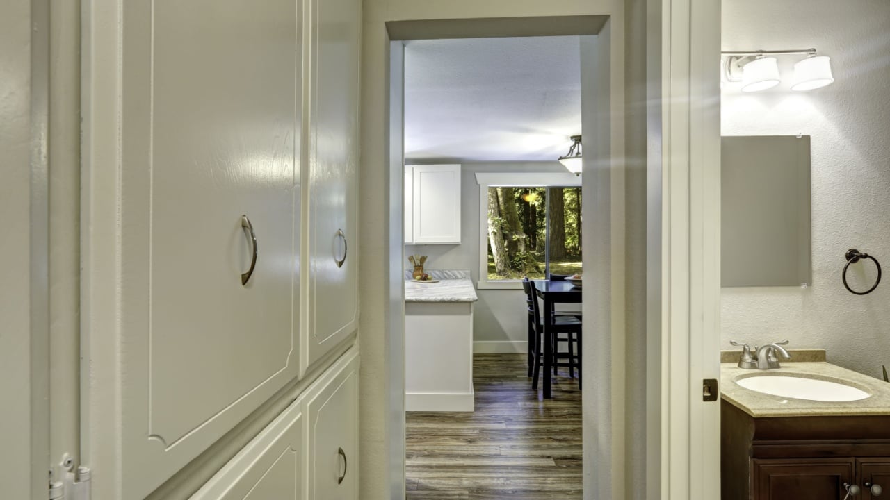 Small walk-through with built-in cabinets and exit to bathroom and kitchen room