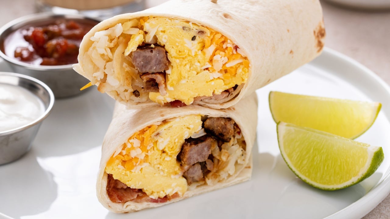 Breakfast burrito with sausage, scrambled eggs, hashbrown potatoes and cheese