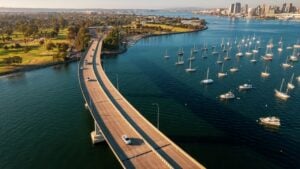 Aerial view of Coronado Bridge in San Diego bay in southern California on a warm sunny day with boats in the bay and cars crossing the bridge