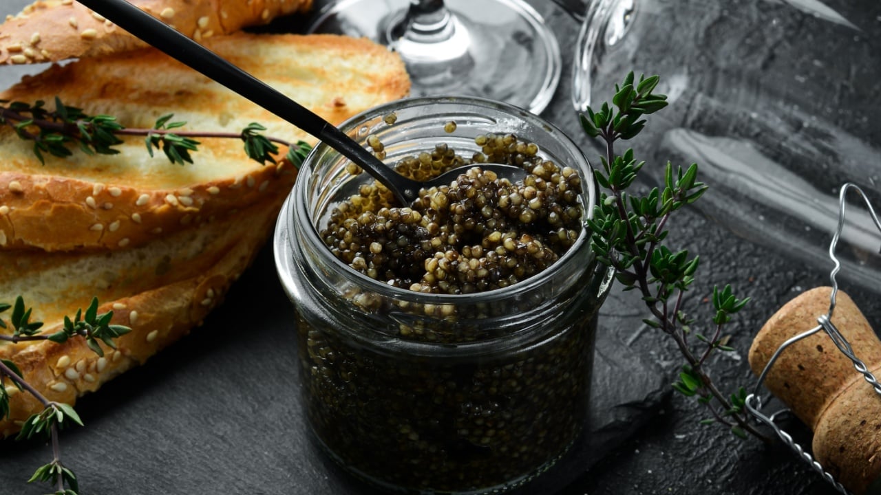 Beluga black caviar. High-quality caviar. On a black background.