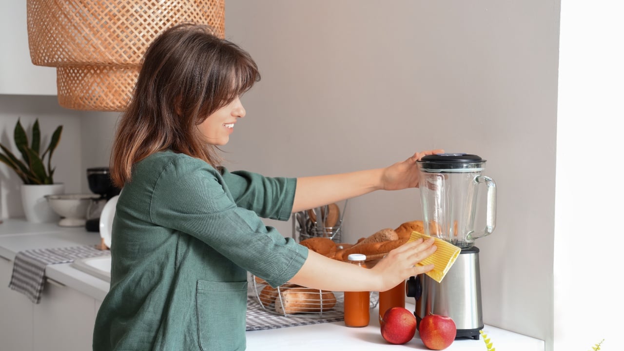 woman cleaning the blender