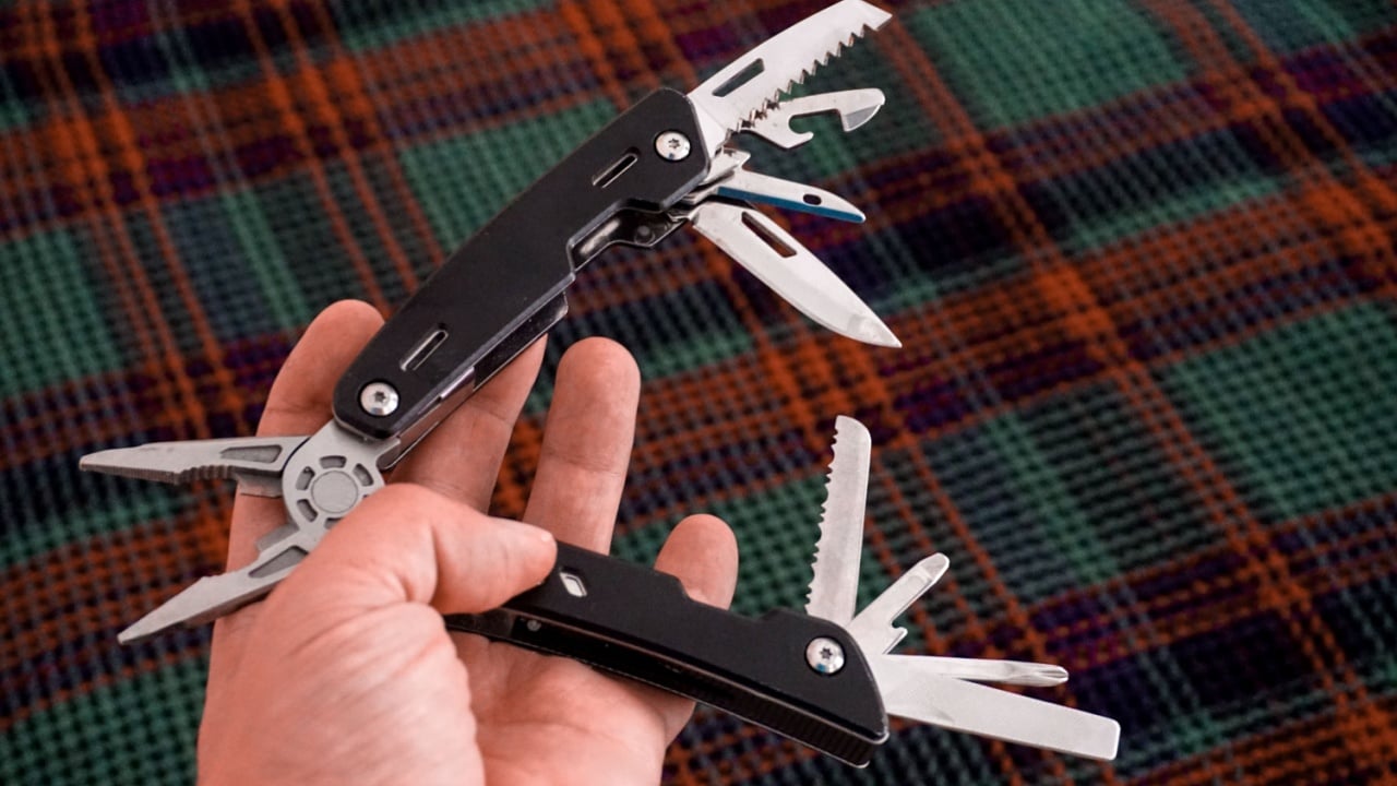 Man holding multi tool in hand close up view