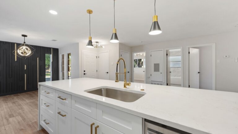 a home kitchen with an island sink