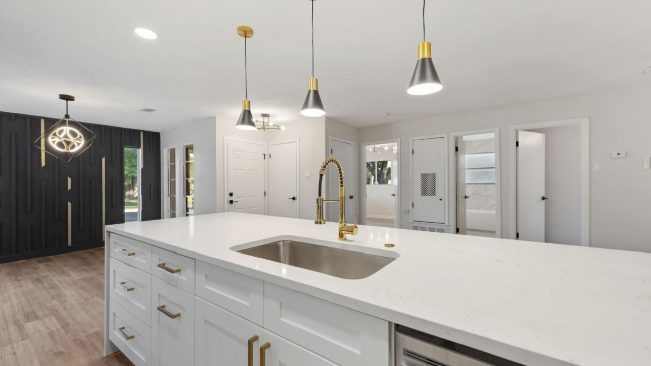 a home kitchen with an island sink