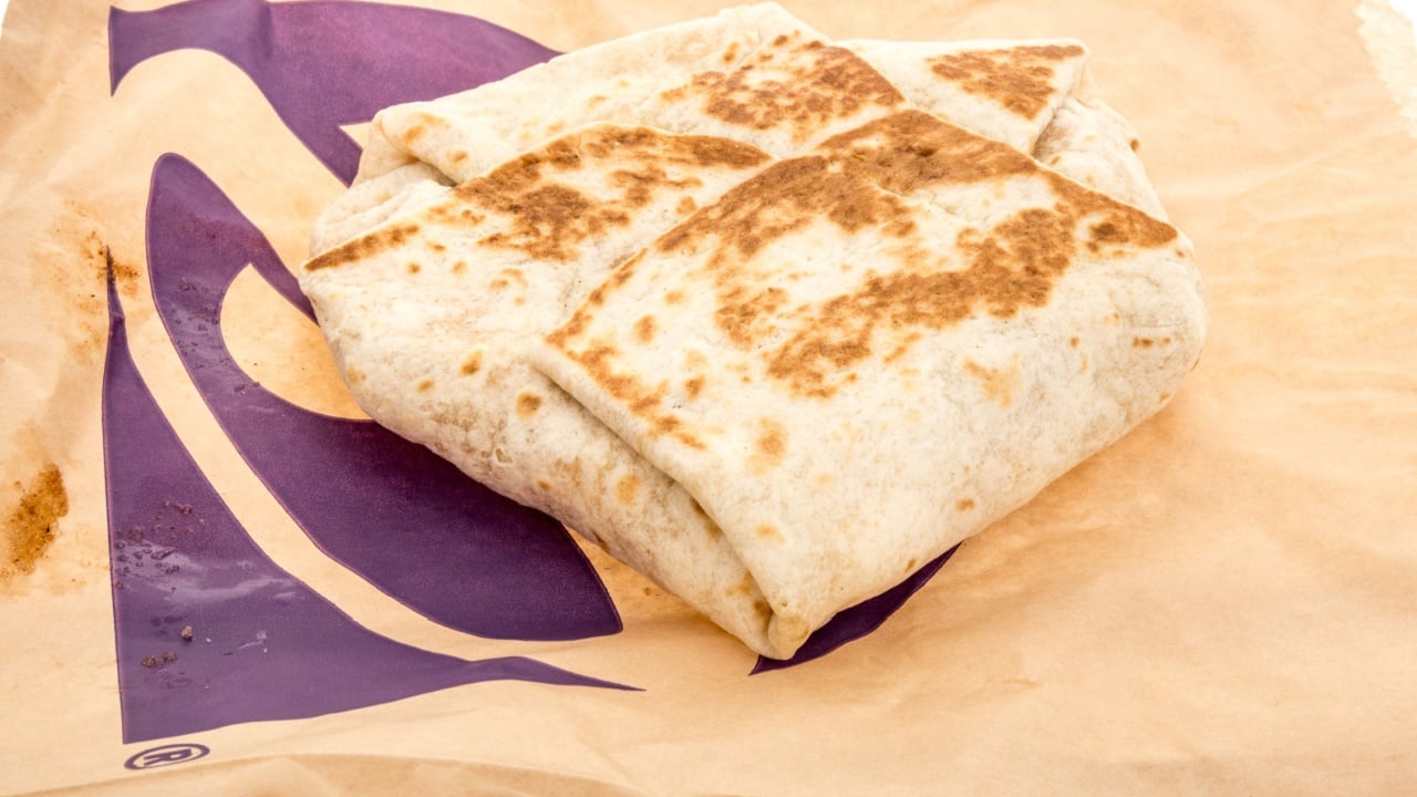 Winneconne, WI - 15 March 2024: A package of Taco Bell breakfast crunchwrap on an isolated background.